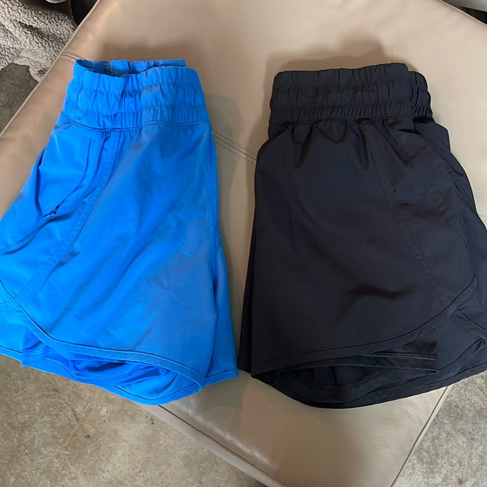 Two pairs of woman’s athletic shorts size small. Black and blue